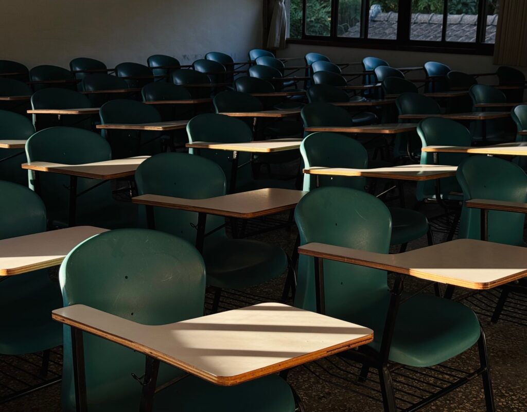 Empty classroom with desks in afternoon sunlight