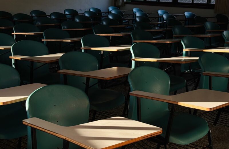 Empty classroom with desks in afternoon sunlight