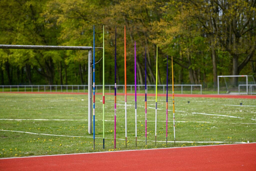 Javelins lined up beside the athletics track