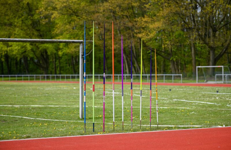 Javelins lined up beside the athletics track