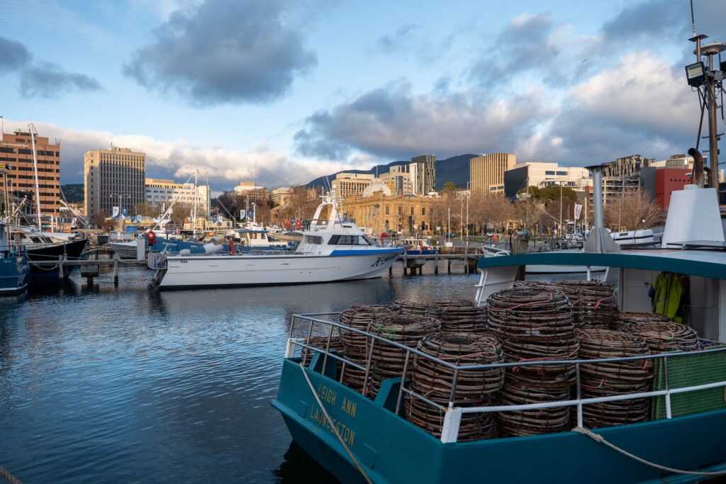 Fishing boats with stacked crab pots at a harbour quay