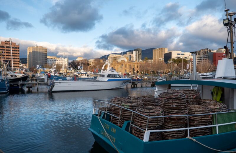 Fishing boats with stacked crab pots at a harbour quay