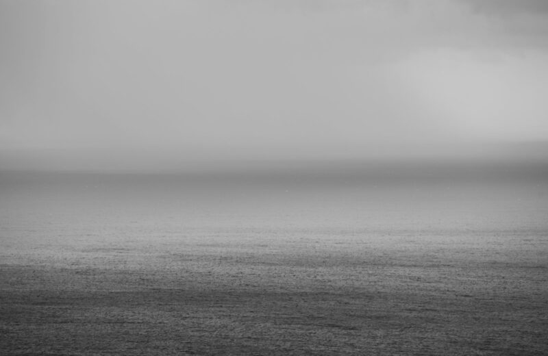 A calm sea and horizon in soft black and white