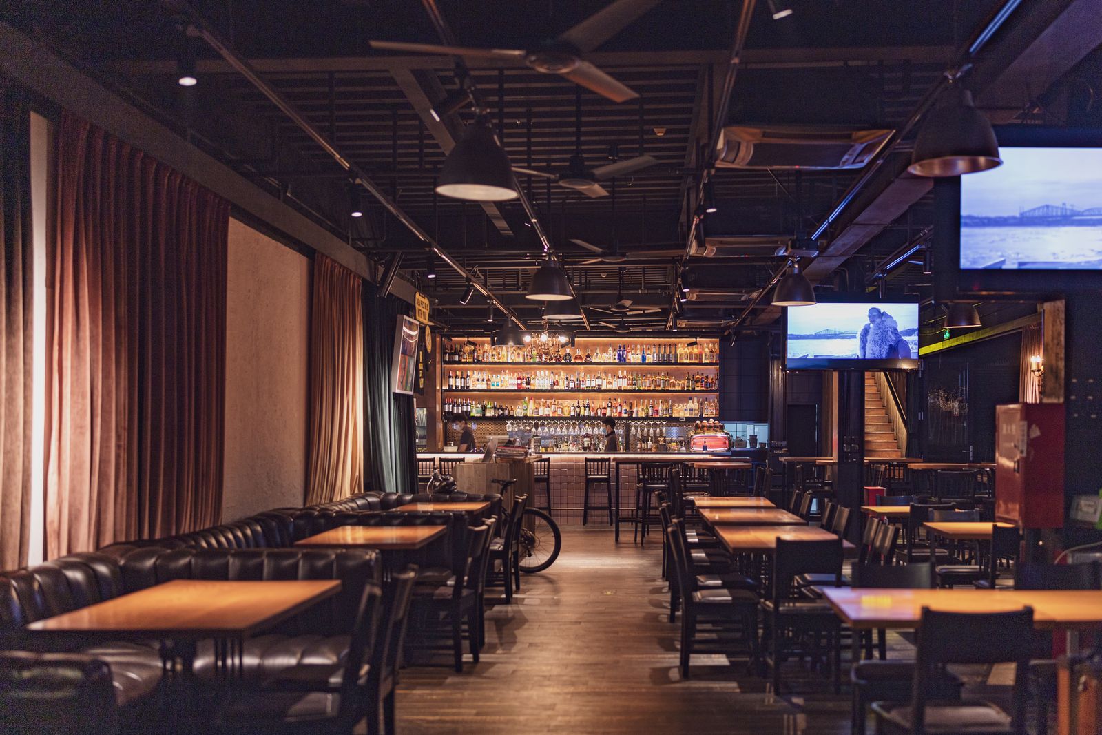 Club bar with tables, chairs and screens for matchdays
