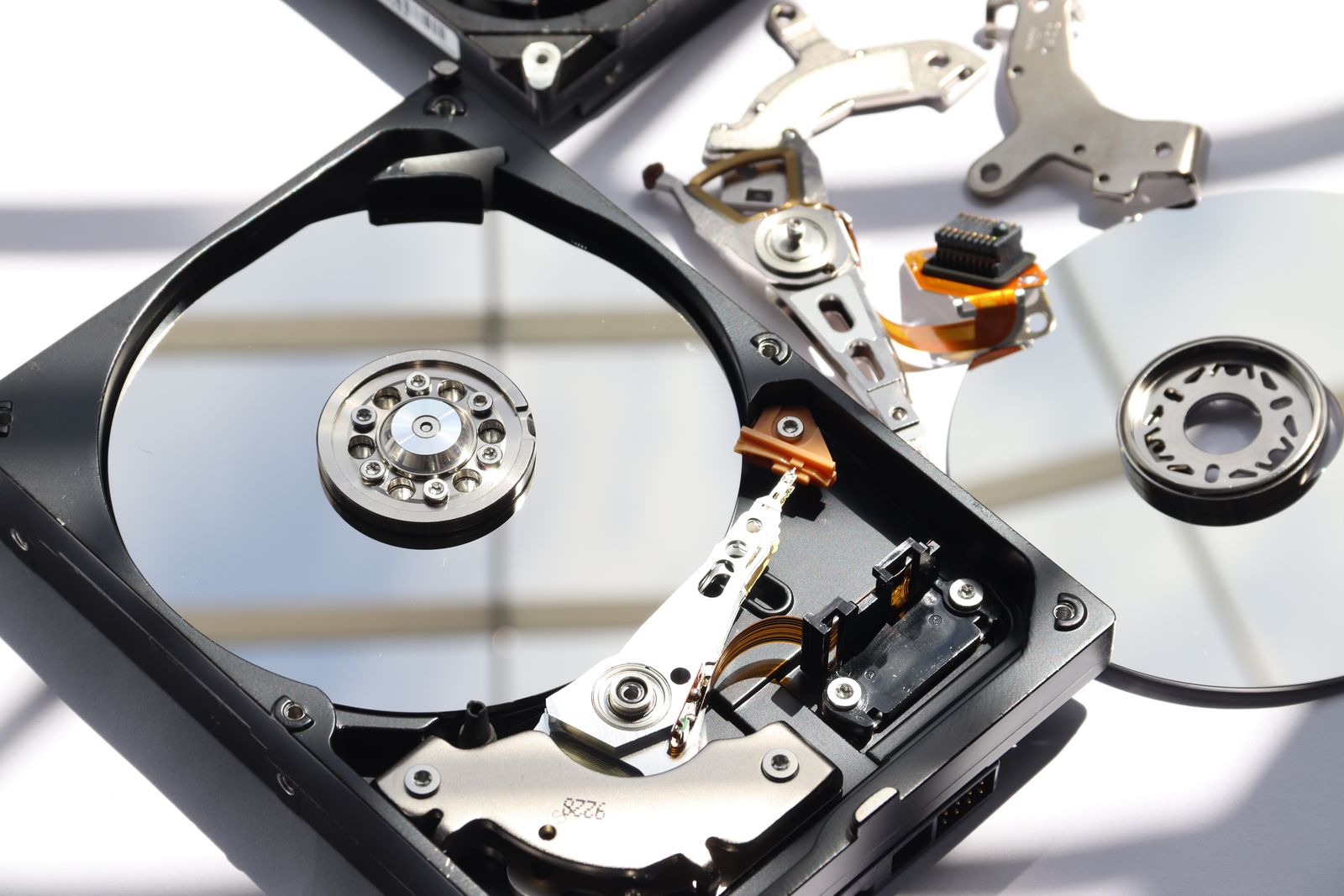 An opened hard disk drive showing its platters and read arm
