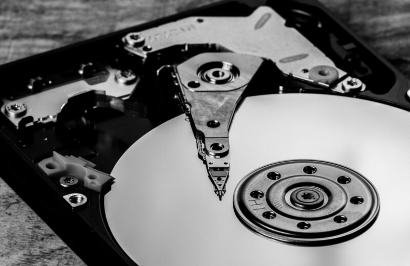 A black and white close-up of an opened hard drive