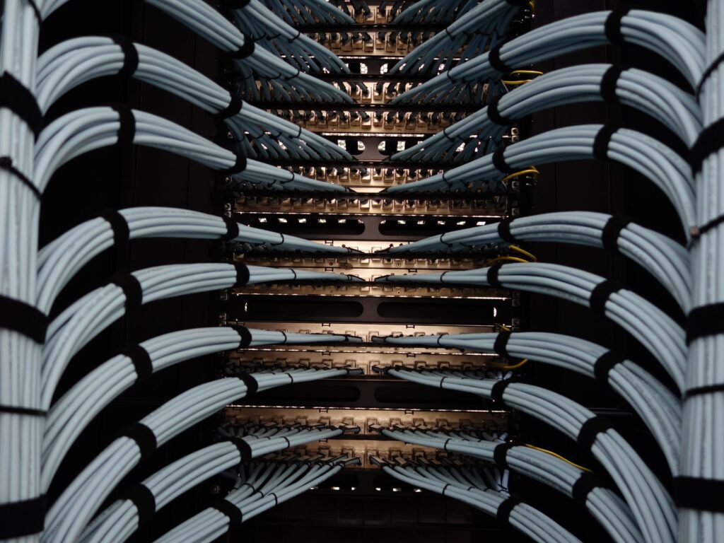 Bundles of grey network cables neatly dressed into a rack