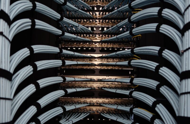 Bundles of grey network cables neatly dressed into a rack