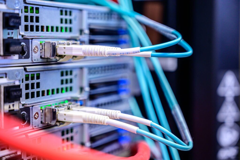 Aqua fibre and grey network cables plugged into server ports