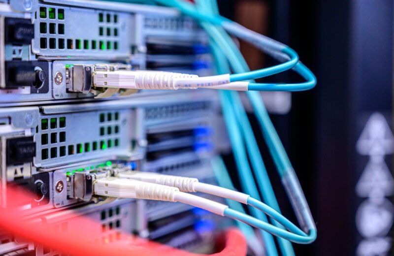 Aqua fibre and grey network cables plugged into server ports