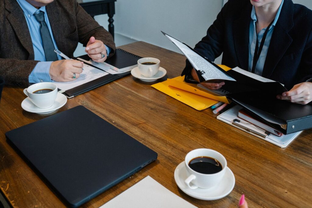 Colleagues at a table with documents and cups of coffee