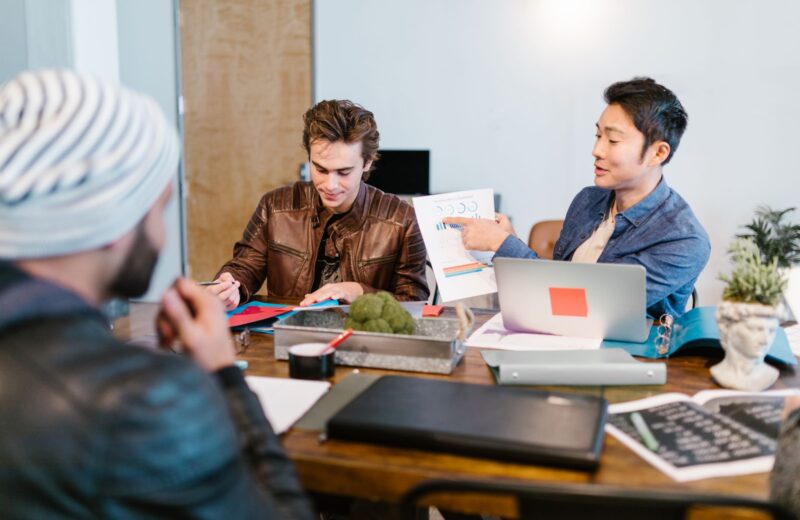 Colleagues discussing project notes in a modern office