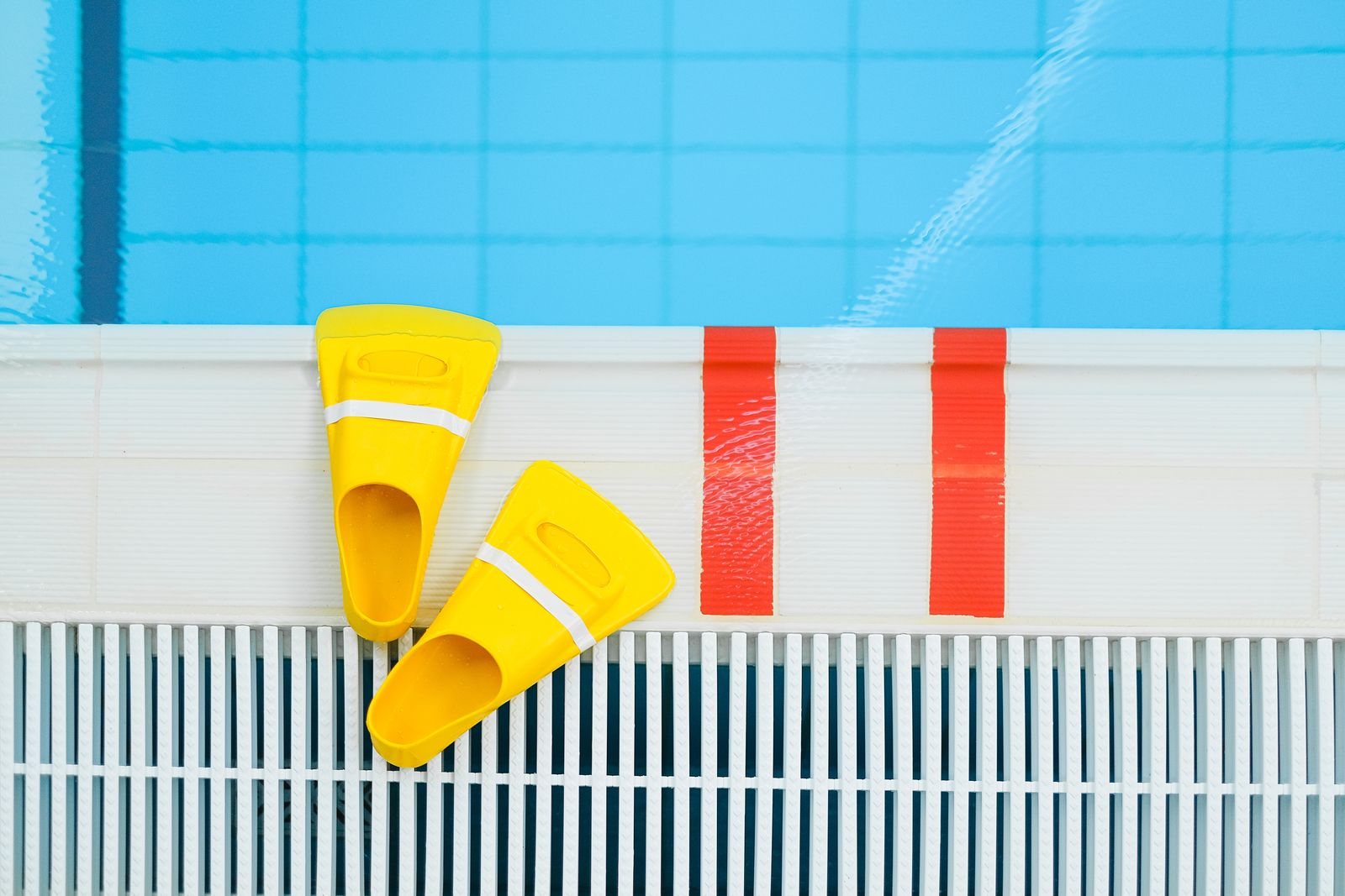 Swim fins on the edge of the pool