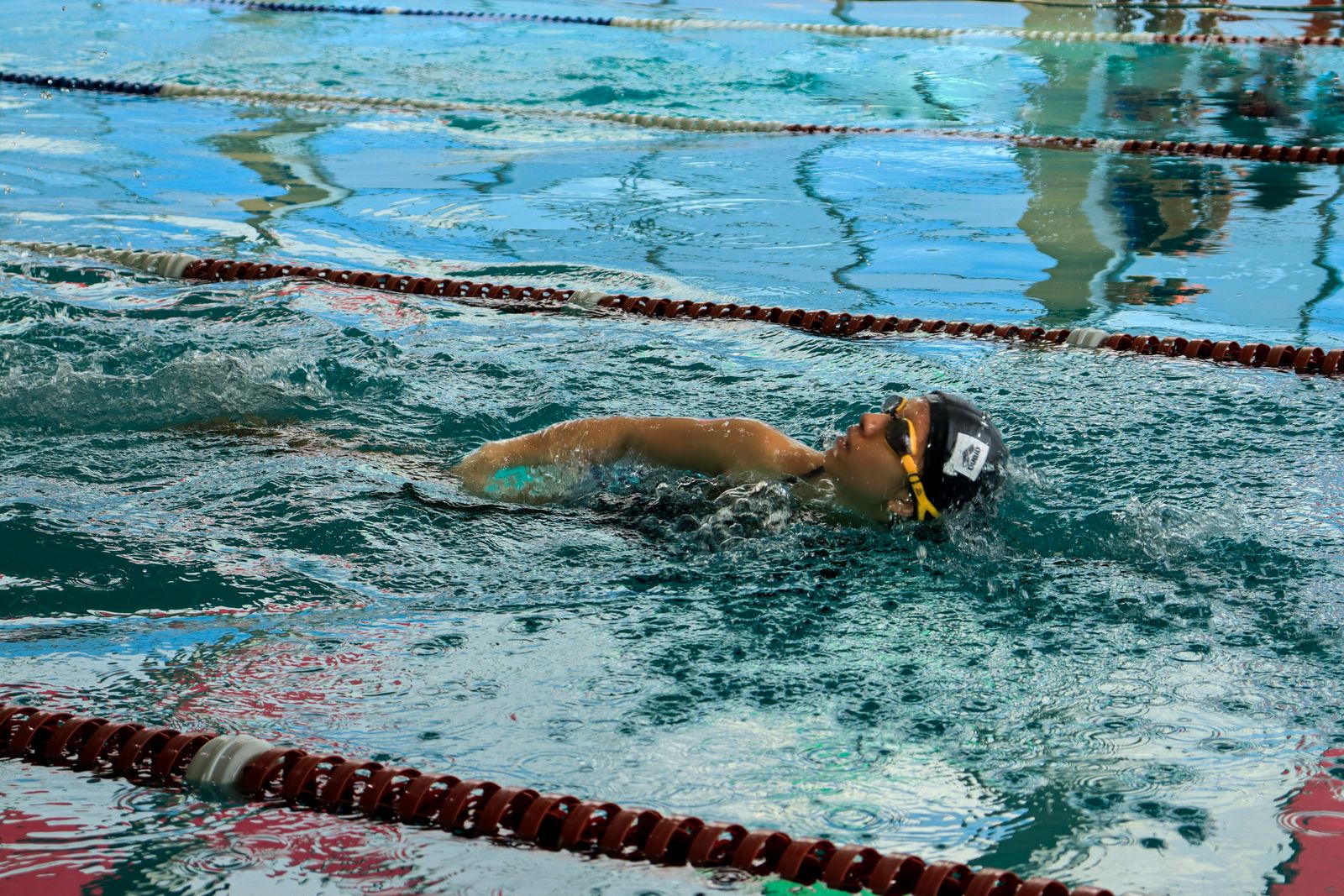 Swimmer gliding underwater along the lane rope
