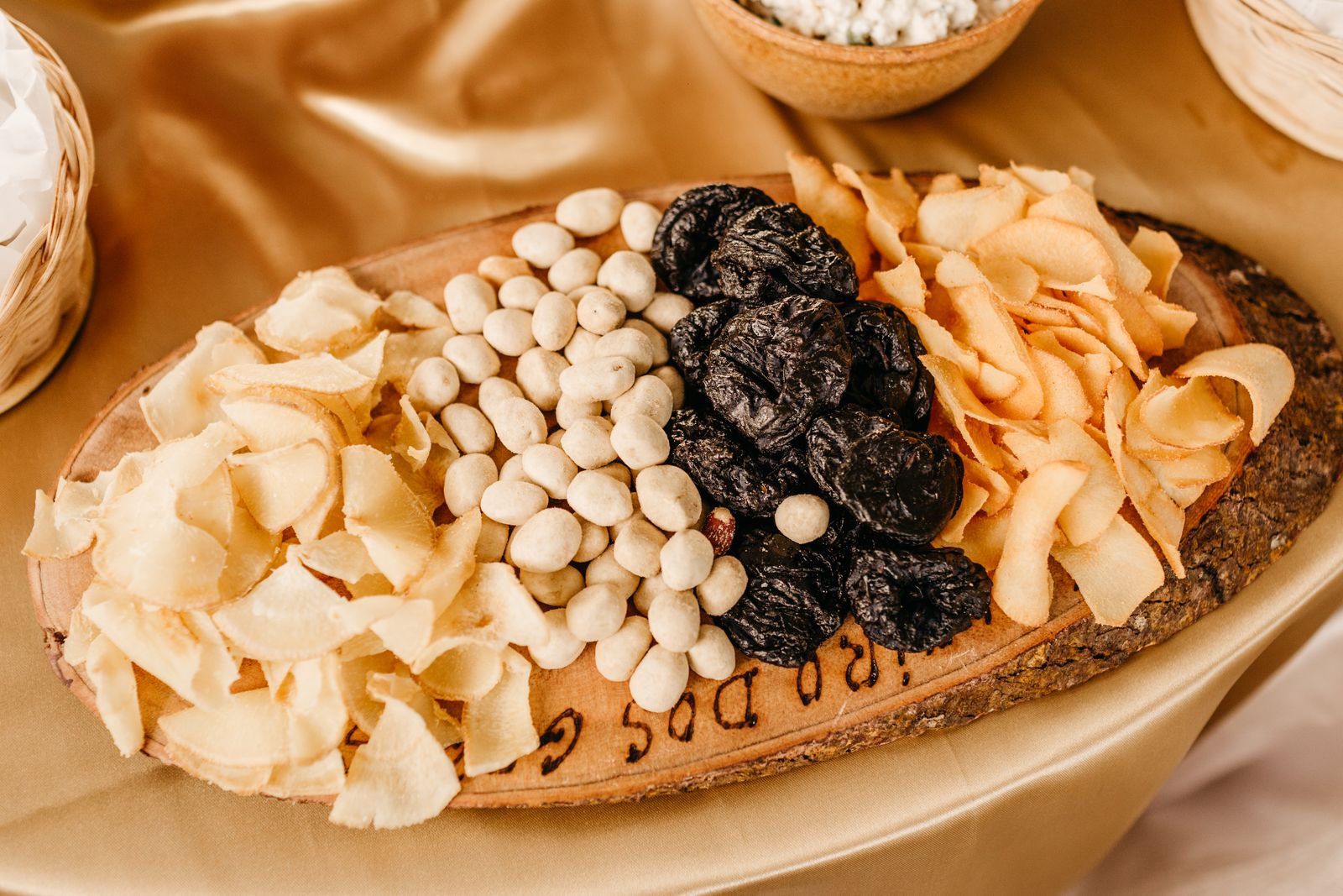 Dried apricots, figs, almonds and walnuts on a wooden tray