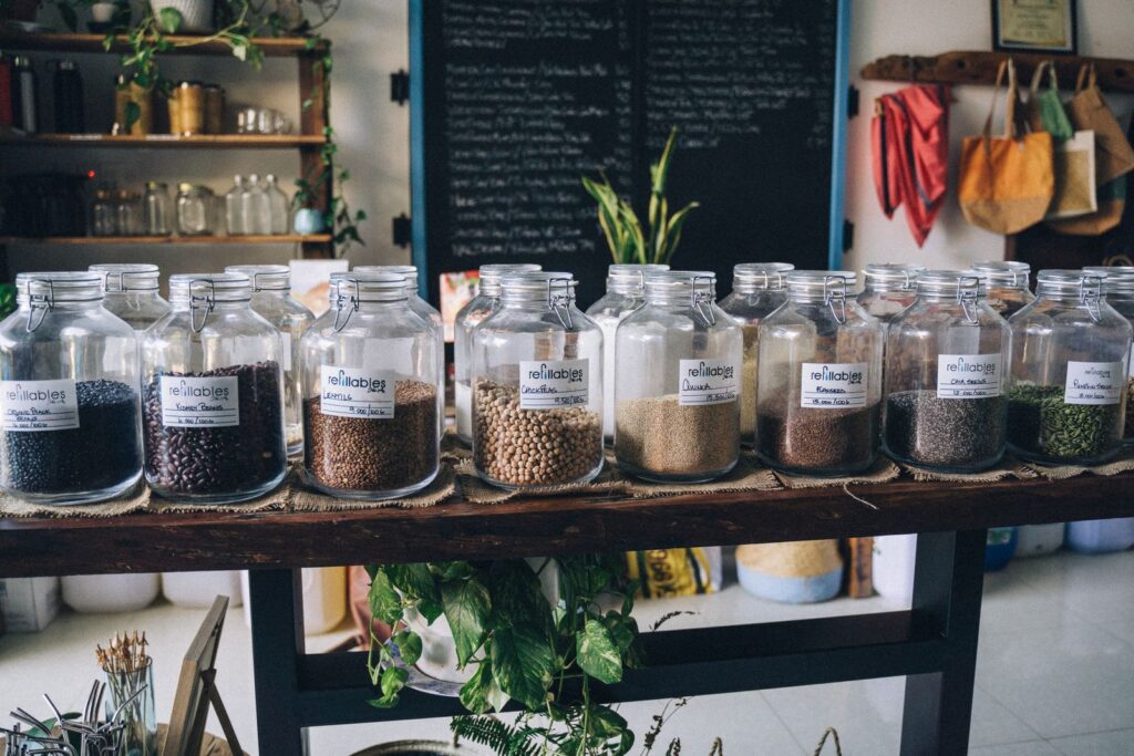 Rows of glass refill jars with seeds and grains in a shop