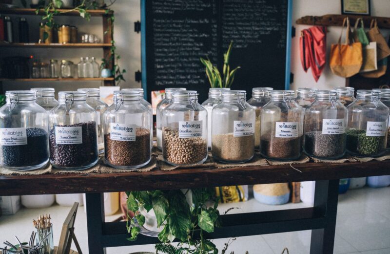 Rows of glass refill jars with seeds and grains in a shop