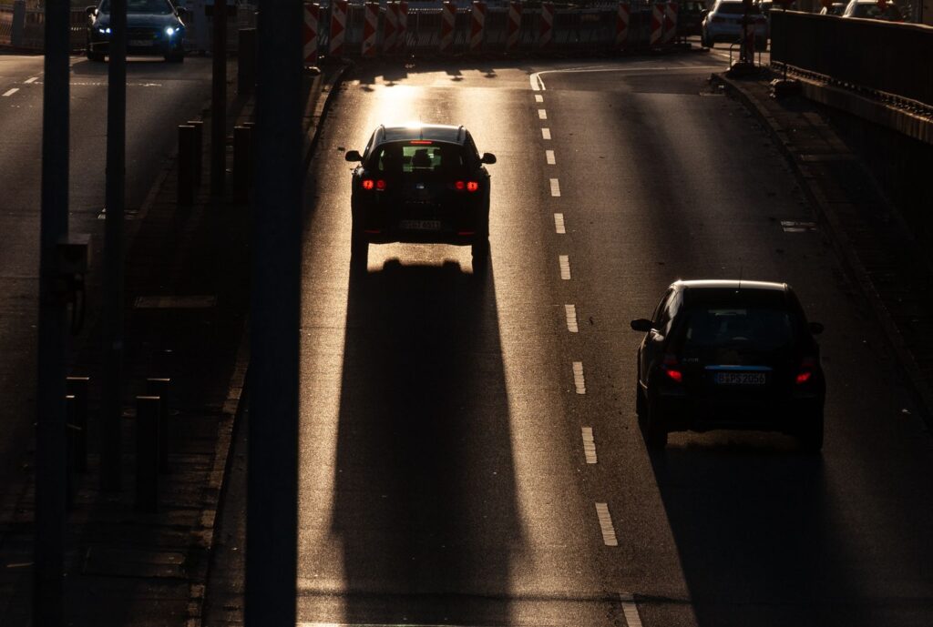 Cars driving along a city road in the evening light