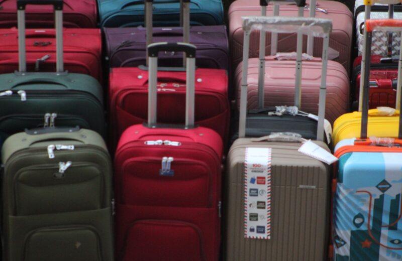 Suitcases of different colours stacked together