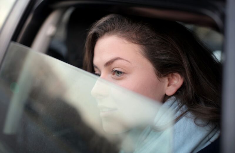 A passenger looking out of a car window