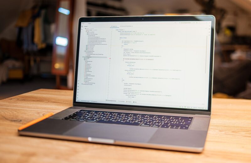 Open laptop on a wooden desk in a quiet office
