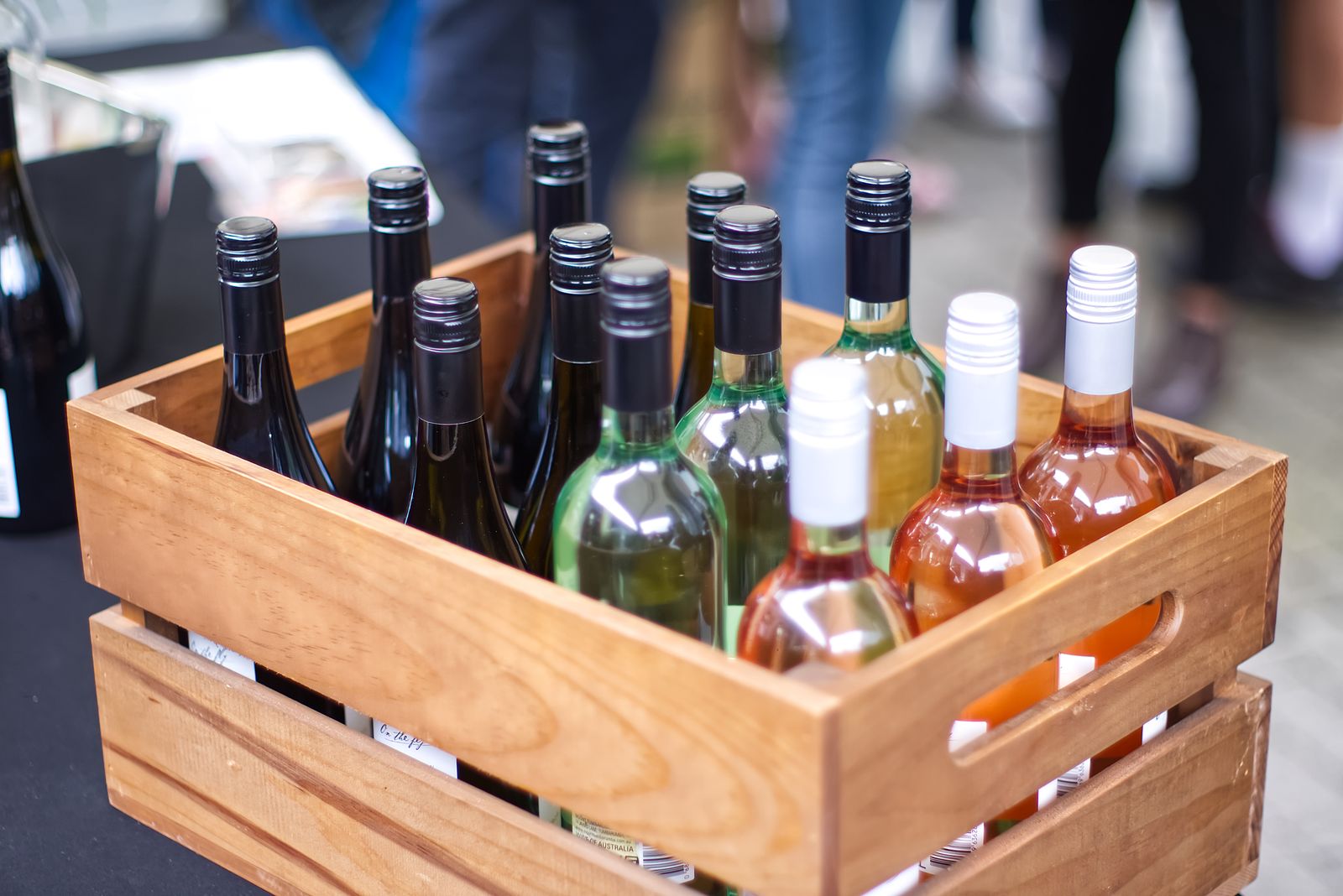 A wooden crate packed with a mixed case of red, white and rosé bottles